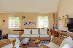 A living room with a sofa, coffee table, and a TV. - w* | Charming 2BR w/ Pool & Terrace in Getsemani (Cartagena de Indias)