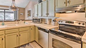 A kitchen with light green cabinets, a stainless steel range, a microwave, and a dishwasher. - 3BR Riverfront Retreat 1 Min to Vail or BC Shuttle (Eagle-Vail)