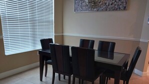 A dining area with a rectangular table and six chairs. - Beautiful, spacious, family friendly private home! one (Port St. Lucie)