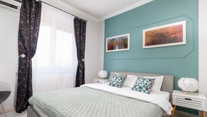 Ein modernes Schlafzimmer mit Bett, Nachttischen und Schreibtisch.
