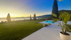 A pool area with a view of the sea and distant hills. - Stunning new villa with beautiful lake view (Bardolino)