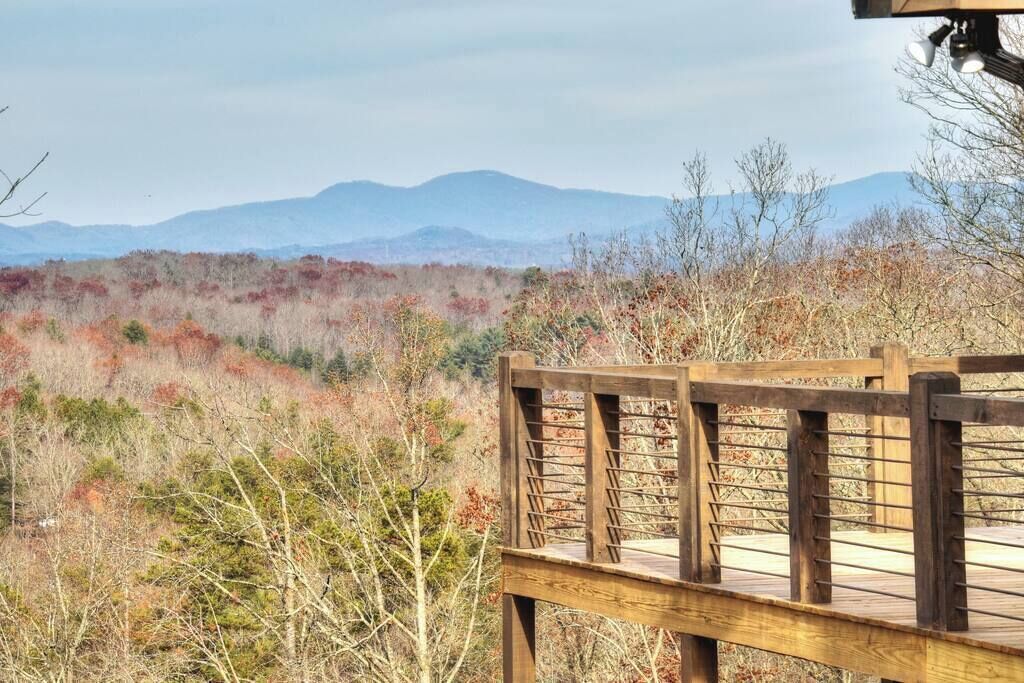 A wooden deck with a view of a mountainous landscape.