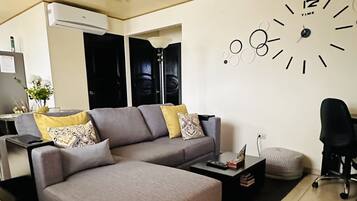 Deluxe Apartment, 2 Bedrooms, Kitchen | Living area | 55-inch Smart TV with cable channels, TV
