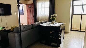 Deluxe Apartment, 2 Bedrooms, Kitchen | Living area | 55-inch Smart TV with cable channels, TV