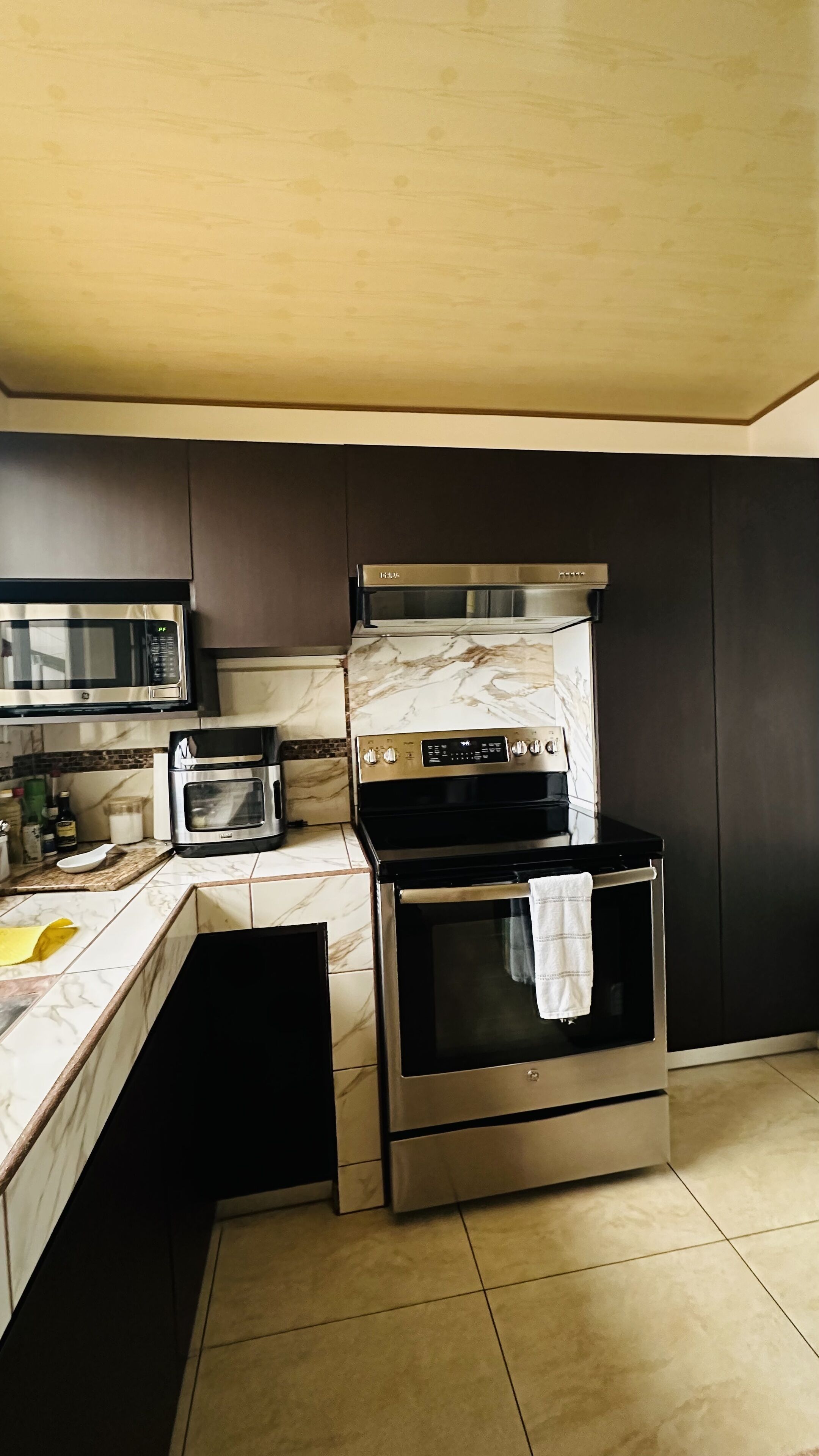 A kitchen with a microwave, toaster, and oven.