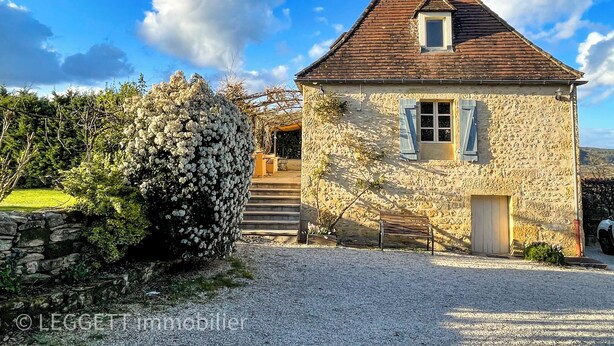 A stone house with a pitched roof, a wooden staircase, and a gravel driveway. - Le Bonheur dans notre Pré, group property with 5 gites (Sainte-Mondane)