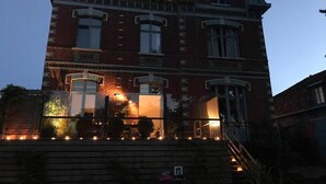 A large, multi-story building with a prominent tower and arched windows. - Villa Marguerite (Saint-Omer)