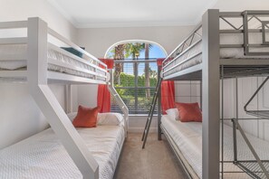 A bunk bed room with a window and curtains. - Spacious Ocean Retreat~Minutes to the Beach, BBQ, Pool, Beach Gear, and More! (Destin)