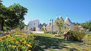 A traditional village with stone houses and a central white building.