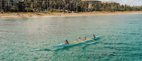 A clear view of a beach with a row of buildings in the background.