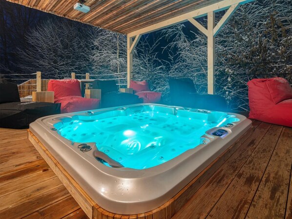 A hot tub in a wooden deck area with a view of frosted trees. - Celadna Mcmh530 in Celadn (Celadna)