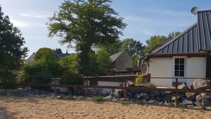 A rustic building with a sloped roof, a satellite dish, and a white door. - Dream vacation apartment on an idyllic farm near Eltz Castle (Münstermaifeld)