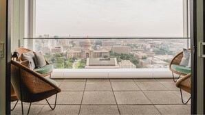 A balcony with two wicker chairs and a view of a cityscape. - Hyatt Centric Congress Ave Austin (Austin)