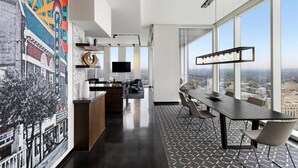 A modern office space with a large conference table, a TV, and a city view through large windows. - Hyatt Centric Congress Ave Austin (Austin)