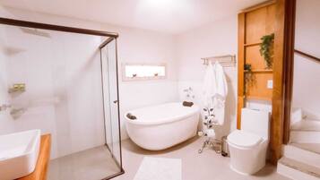 A bathroom with a bathtub, toilet, and sink.