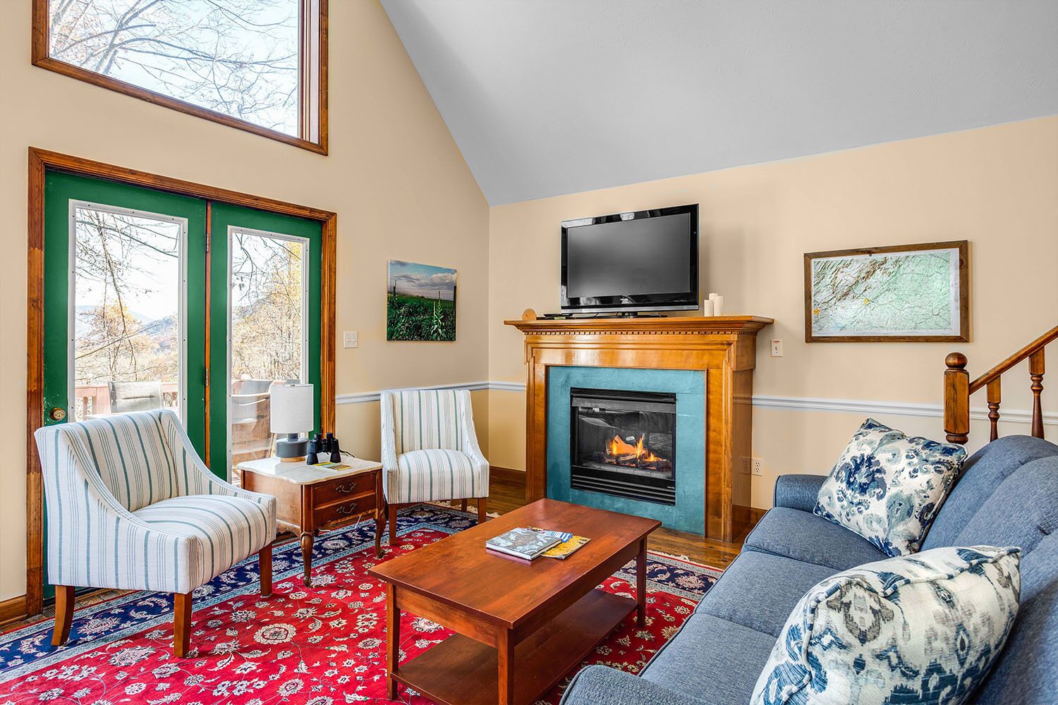 A living room with a fireplace, a television, and a sofa.