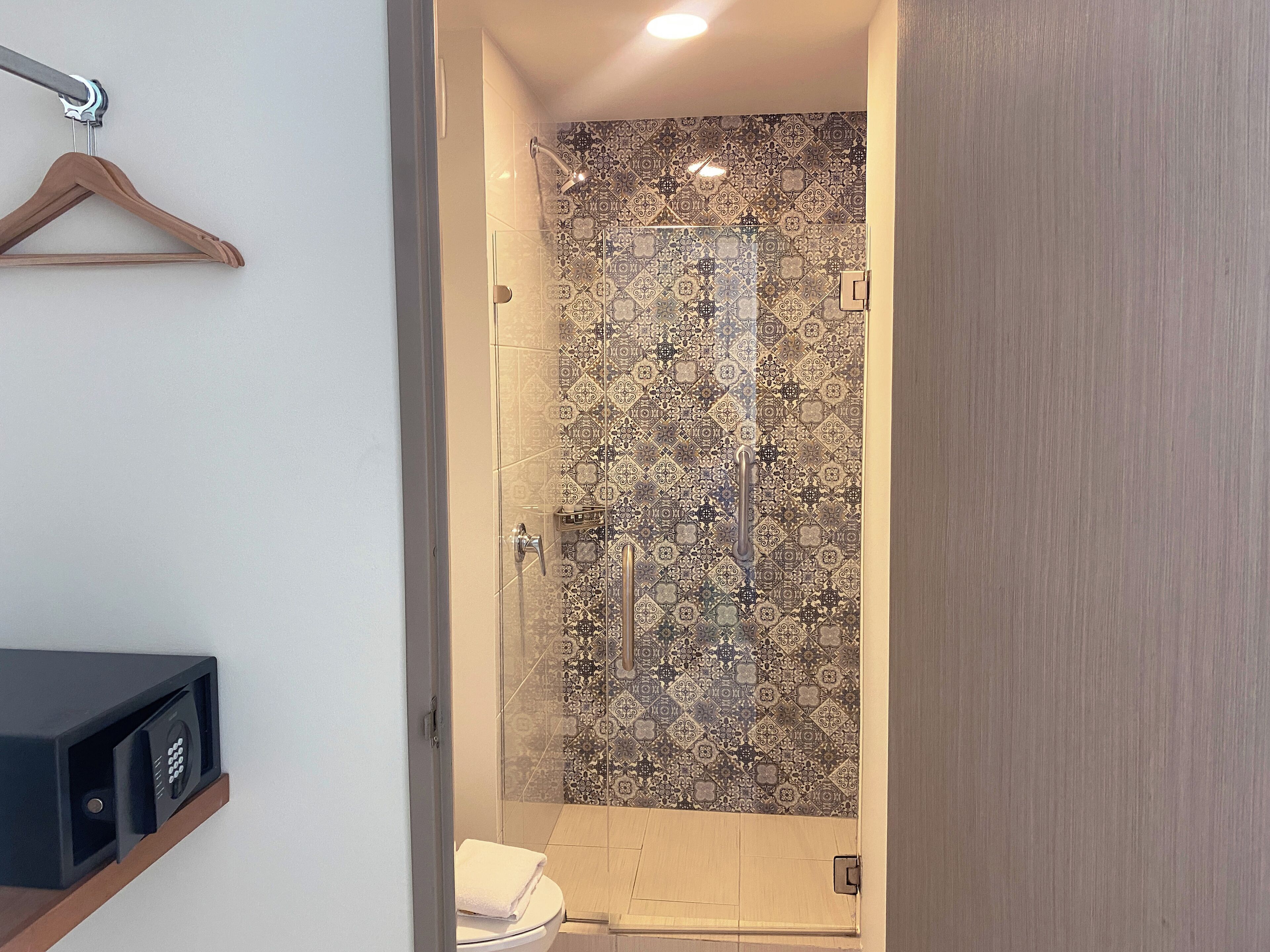deluxe room, 2 queen beds | bathroom | shower, rainfall showerhead, towels