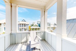 Enjoy a balcony with a view of charming neighboring homes.