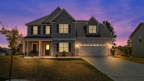A two-story house with a garage, a front porch, and a driveway. - Spacious 4 BD Golf Getaway with Game Room! (Aberdeen)