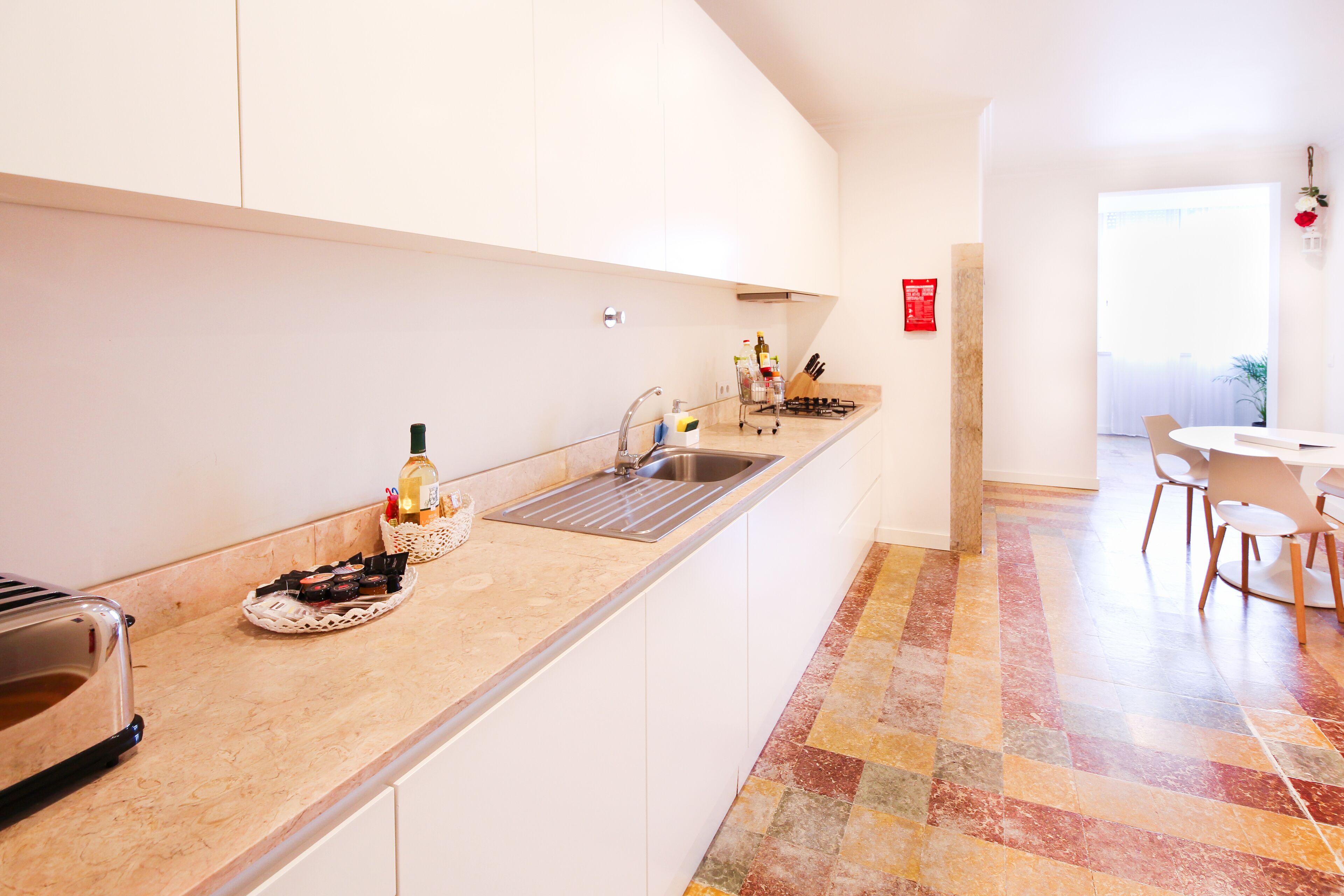 A modern kitchen with a built-in sink, a toaster, and a breakfast bar.