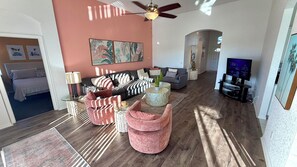 A modern living room with a sofa set, a coffee table, and a television.