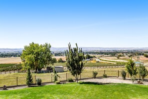 Enjoy breathtaking views of rolling fields and distant mountains from this serene property.