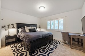 A bedroom with a bed, bedside lamps, a desk, and a window. - Private 1+ acre, Bocce, Waterfall, Free Pool Heat (Santa Rosa)