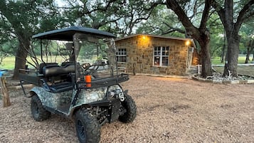 Guests can enjoy a cabin with a porch area and golf cart access.