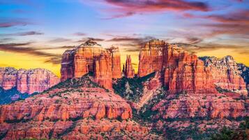 A rugged mountain landscape with prominent rock formations and sparse vegetation.