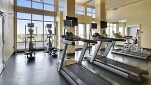 A fitness center with treadmills, elliptical machines, and stationary bikes.
