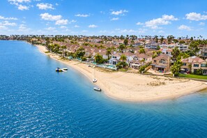 A coastal residential area with beachfront properties, a sandy beach, and clear blue waters. - Coronado Cays Beachfront with Private Pool & Spa (Coronado)