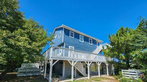 A two-story house with a covered porch and a staircase leading to the upper floor. - The Last Resort ⛱️High on a dune with spectacular views - 4 BR/2 BA oceanside home in Duck⛱️ (Duck)