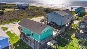 A coastal house with a balcony and a view of the beach. - Steps from the Beach!  (Crystal Beach)