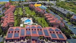 A resort with multiple buildings, a swimming pool, and a view of the ocean. - Maui Paradise: Steps to Sand-Blg#1. Partial Ocean View, AC's, Wifi, 1st Floor (Kihei)
