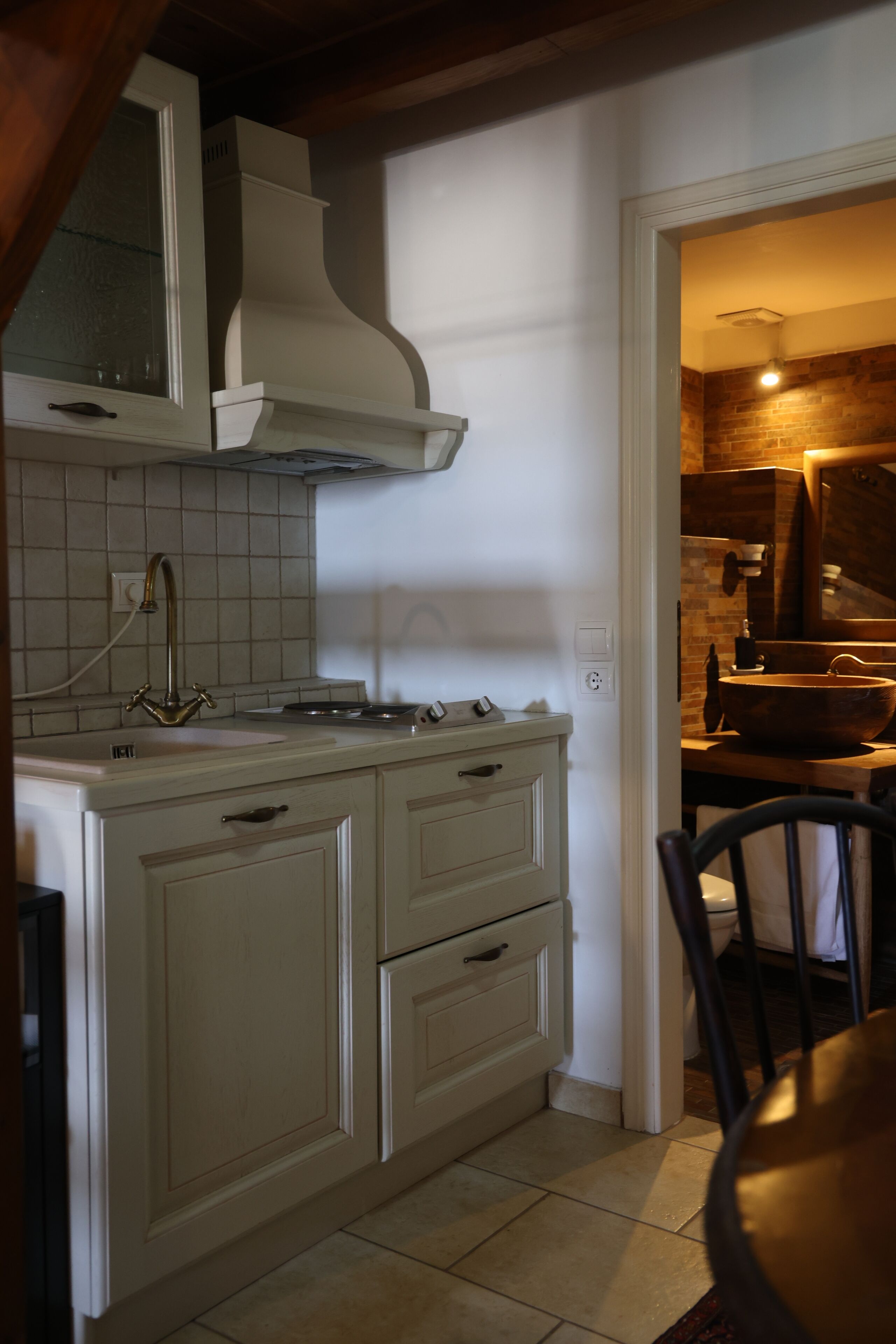 A kitchen with white cabinets, a stove, and a sink.