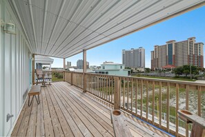 Relax on the deck with a city view, featuring a bench and table.