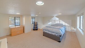 A bedroom with a bed, a dresser, a window, and a skylight. - Gold Medal Trout Fishing at the Door - 2BR Cabin, 22mi to Breckenridge (Fairplay)