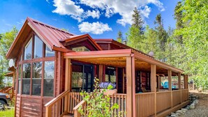 A wooden cabin with a porch, large windows, and a stone pathway. - Gold Medal Trout Fishing at the Door - 2BR Cabin, 22mi to Breckenridge (Fairplay)
