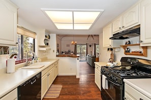 Enjoy cooking in this well-appointed kitchen with a central island, stove, and ample counter space.
