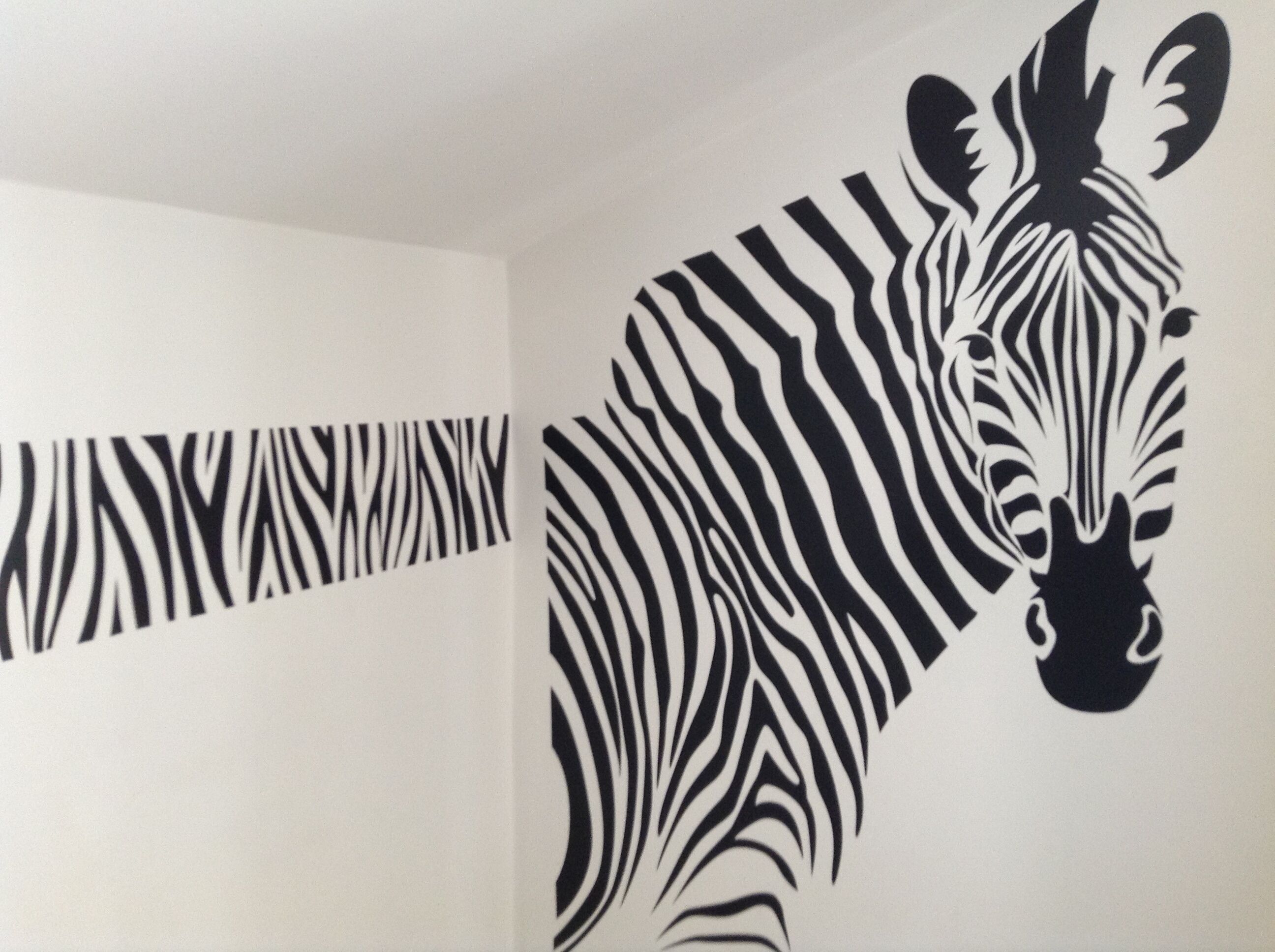 A zebra wall decal in a room.