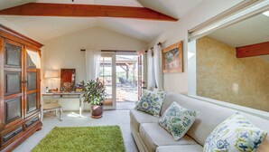 A cozy living room with a sofa, a desk, and a cabinet. - Vineyard Views & Sauna at Cornville Home! (Cornville)