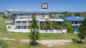 A modern multi-story hotel with a prominent entrance, a covered outdoor area, and a view of the surrounding landscape. - Pippis on Pacific - fantastic two-level townhouse located opposite Yamba's beautiful Pippi Beach (Yamba)
