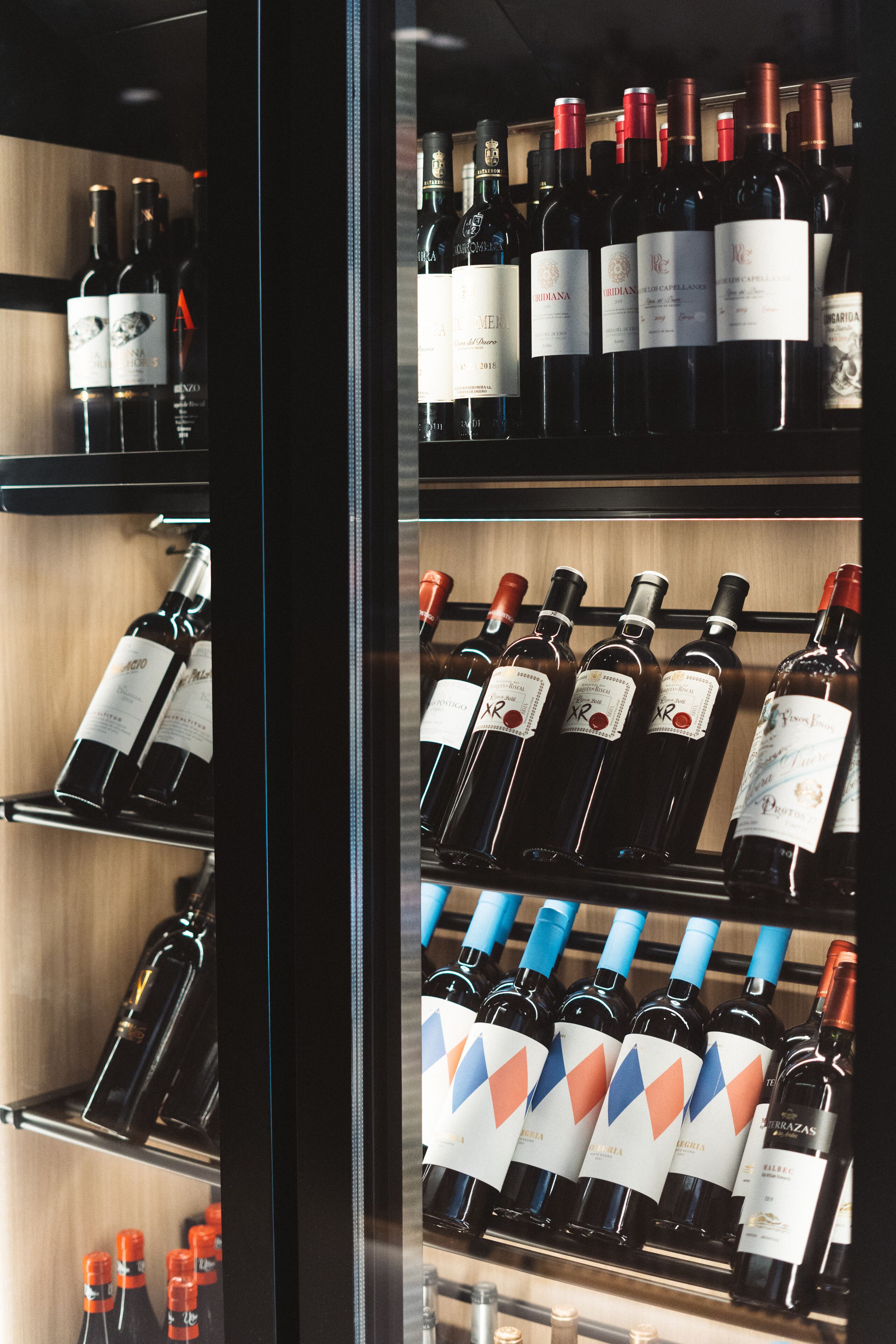 A wine rack with various bottles of wine.