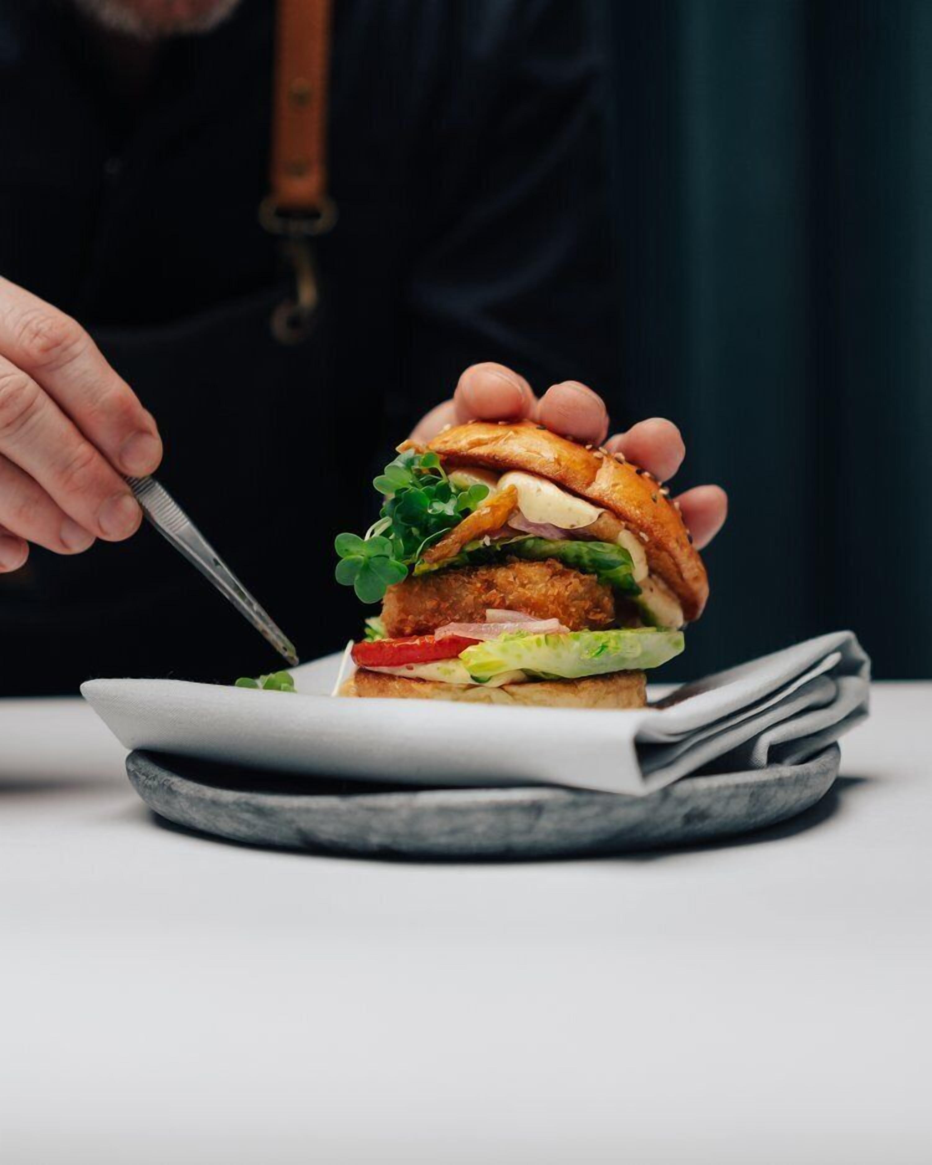 A sandwich on a plate with a fork.
