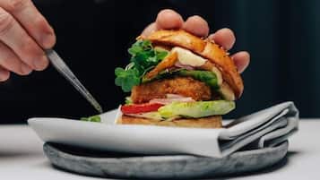 A sandwich on a plate with a fork.