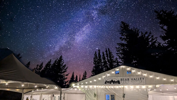 A large tented area with a sign for the Bear Valley Music Festival, under a starry night sky. - Great Location Corner Condo - Tamarack #10 Pets OK - 2 Bedroom Condo by Bear Valley Vacation Rentals (Arnold)