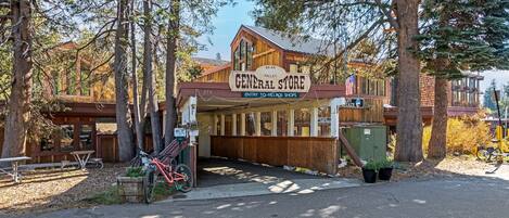 A rustic store named 'General Store' with a wooden facade, located in a wooded area.