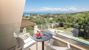 A balcony with a table, chairs, and a bottle of wine. - Stefania - Two Bedroom Villa, Sleeps 4 (Acharavi)