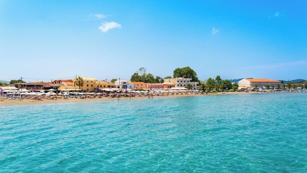 A coastal town with a beach, buildings, and clear blue water. - Stefania - Two Bedroom Villa, Sleeps 4 (Acharavi)