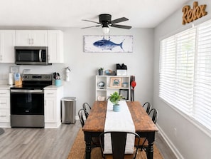 A modern kitchen with white cabinets, a black microwave, and a stainless steel oven. - Short Walk to Beach and Boardwalk with a Pool (Ocean City)